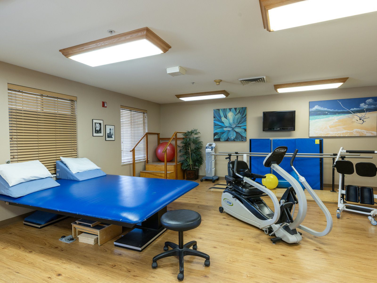 Fitness room with exercise equipment at Alaska Gardens Nursing Home in Tacoma, Washington