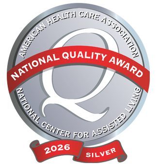 Silver medal badge with a red ribbon reading 'National Quality Award'; 2026 Silver, from the American Health Care Association and National Center for Assisted Living.